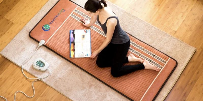 woman laying on PEMF mat